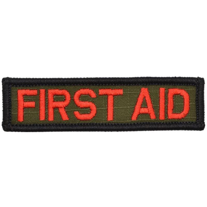 A rectangular first aid patch with red text on a green background.