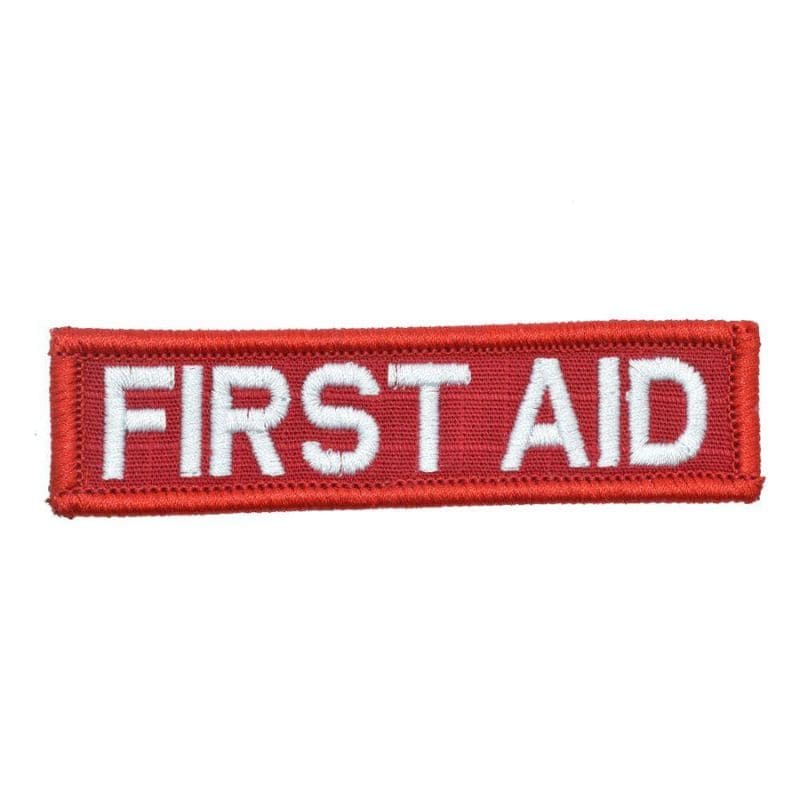 A rectangular first aid patch with white lettering on a red background.