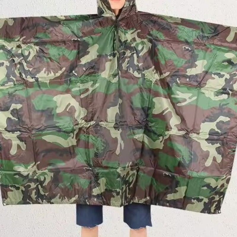 Camouflage rain poncho on a plain background