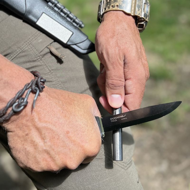 Morakniv Bushcraft Survival Black knife in use with striker tool, premium bushcraft gear, custom kit builds A Way Through the Wilderness